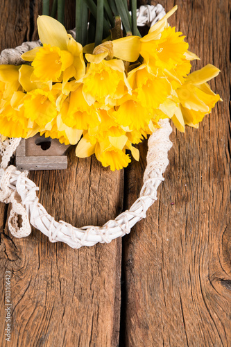 spring narcissus flowers on wooden background