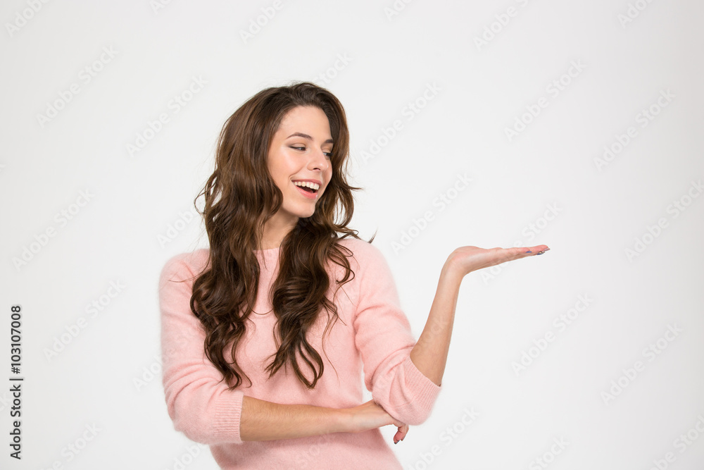Smiling woman holding copyspace on the palm Smiling woman holding copyspace on the palm