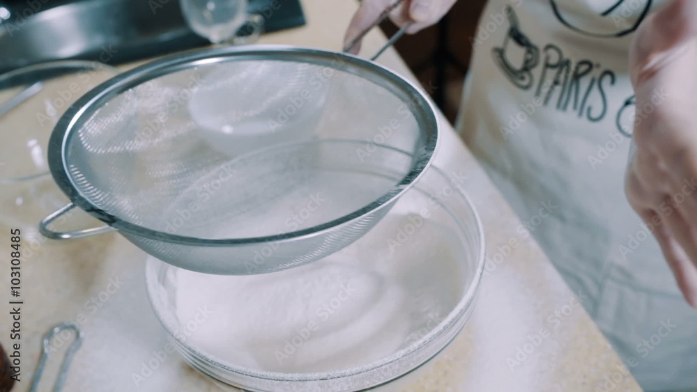 Sifting flour into bowl, slow motion Sifting flour into bowl, slow motion