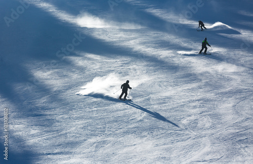 Skiers sliding from mountains