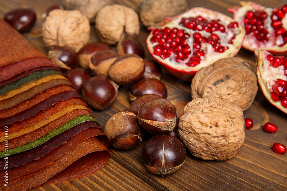 selection of various colorful spices, fruit, nuts on a wooden table