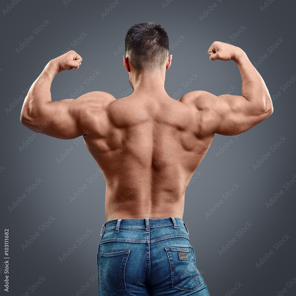 strong muscular man back on grey background фотография Stock | Adobe Stock