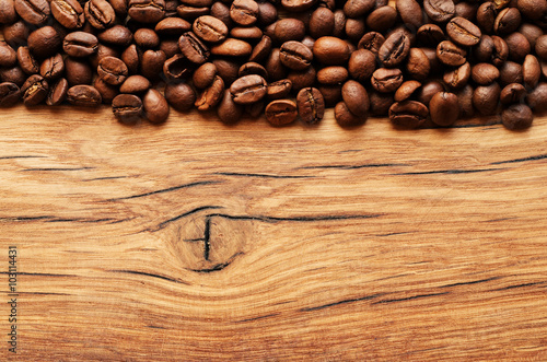 Coffee beans on grunge wooden background