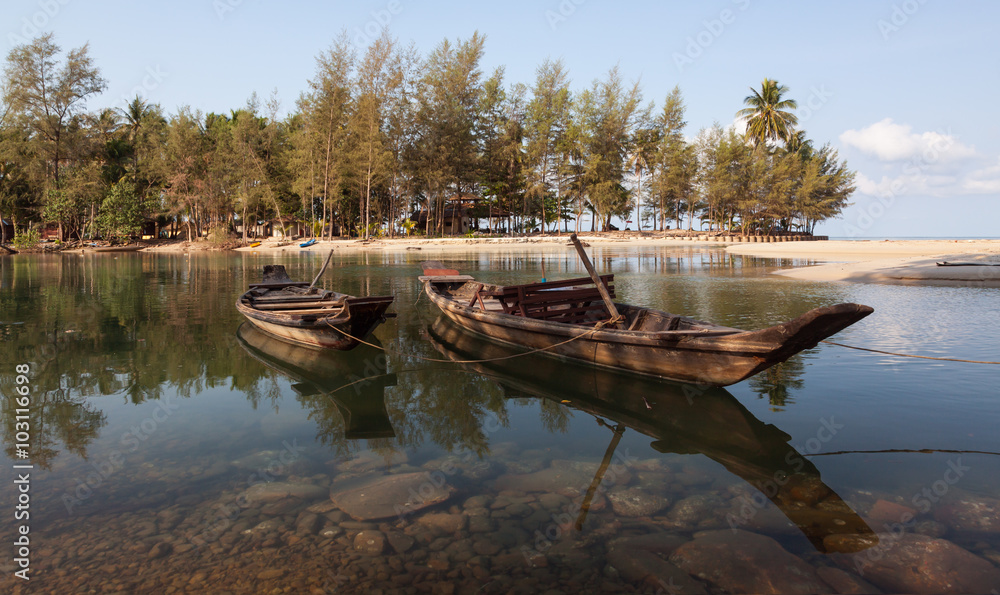 Two boats on the river beach with tropical forest near the sea