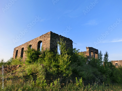 Abandoned shell of a stone building outdoors - landscape color photo