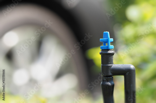 Plant watering micro sprayer sprinkler in garden background