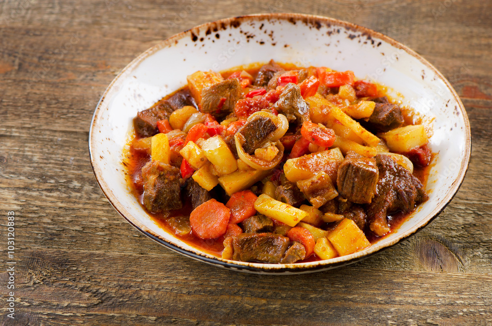 Irish stew with vegetables on rustic wooden table. Irish stew with vegetables on rustic wooden table.
