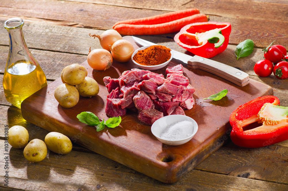 Ingredients for stew on rustic wooden table. Ingredients for stew on rustic wooden table.