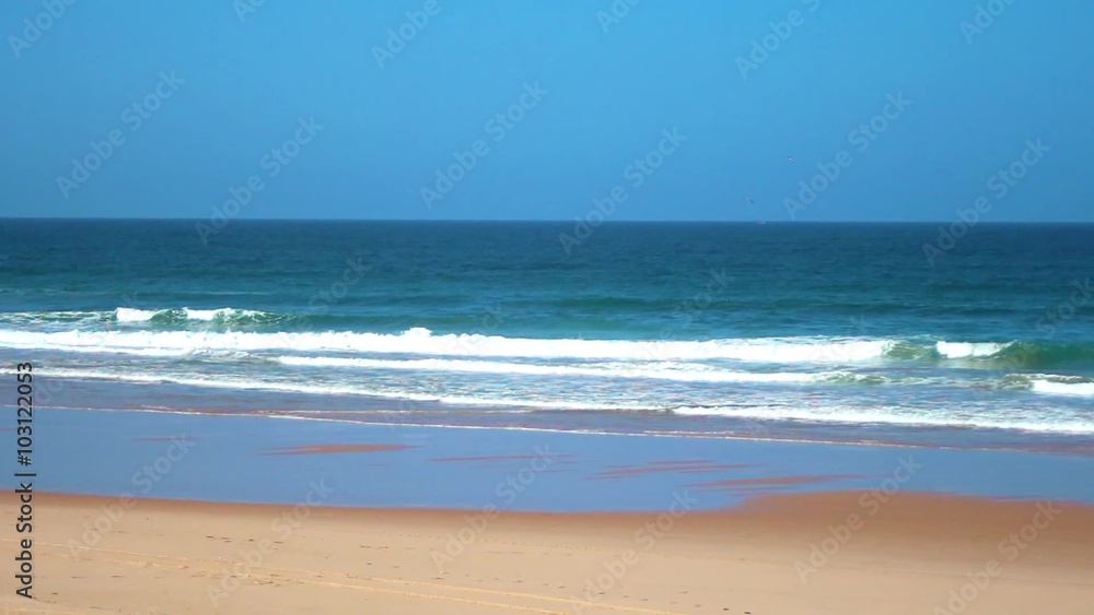 Beach landscape with ocean waves crashing in low tide. Beach landscape with ocean waves crashing in low tide.