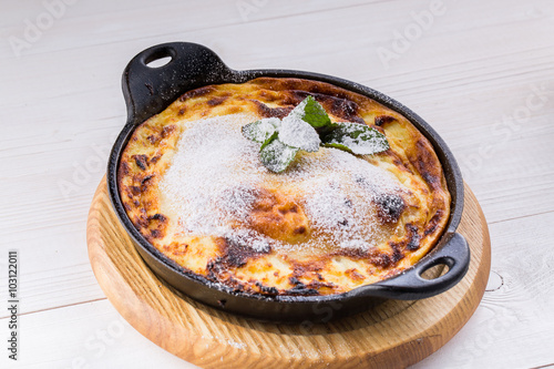 cottage cheese casserole on pan with powdered sugar photo