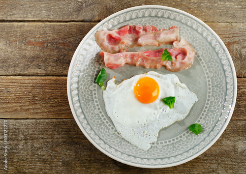Fried egg with bacon for traditional breakfast.