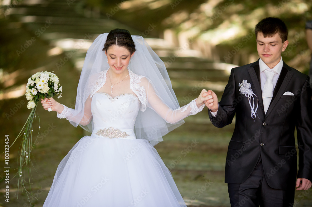 Happy beautiful  wedding girl in white dress and man in black suit