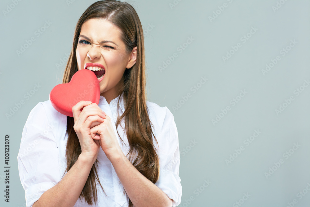 Beautiful woman bite heart. Isolated portrait. Beautiful woman bite heart. Isolated portrait.