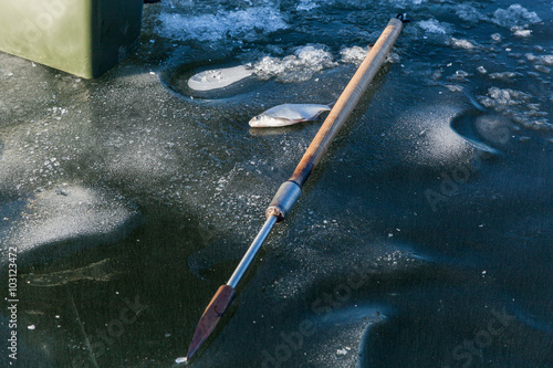 Fish on ice, man on winter fishing, people on the ice of the fro