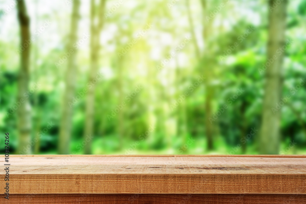 Wooden table and blur forest background. Wooden table and blur forest background.