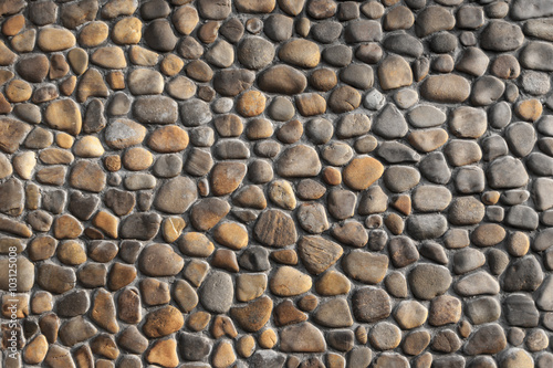 Yellow and brown pebble stone wall