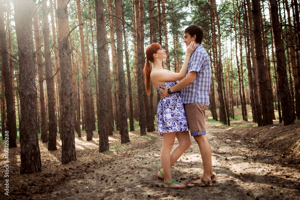 Fototapeta premium a young couple in love walking in the woods
