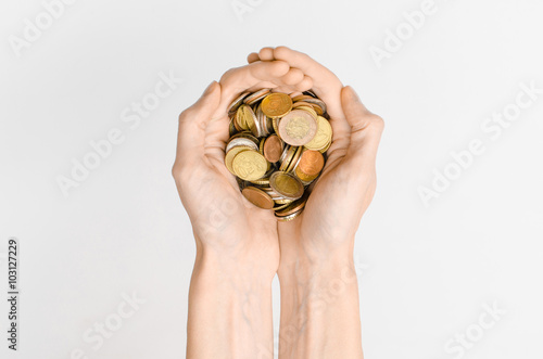 Money and Finance Topic: Money coins and human hand showing gesture on a gray background in studio top view