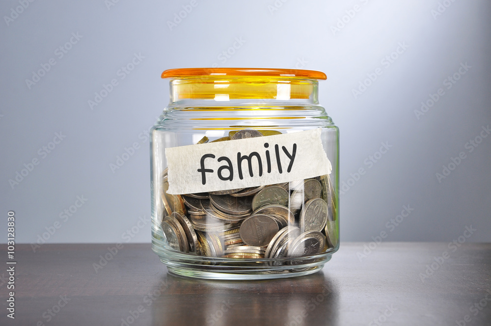 Saving concept of coins in the glass jar for family purpose Saving concept of coins in the glass jar for family purpose