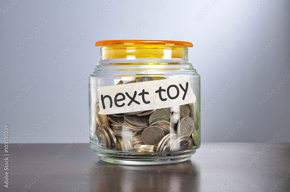 Saving concept of coins in the glass jar for next toy purpose Saving concept of coins in the glass jar for next toy purpose