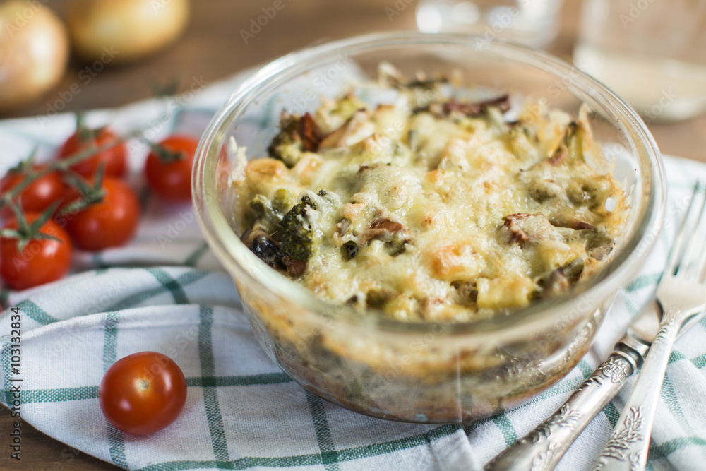 Tomato gratin with cheese and zucchini in baking dish Tomato gratin with cheese and zucchini in baking dish