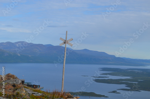Mountain slope with trail mark overlooking lake Torneträsk, subarctic mountains, Swedish Lapland