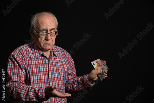 elderly man with money