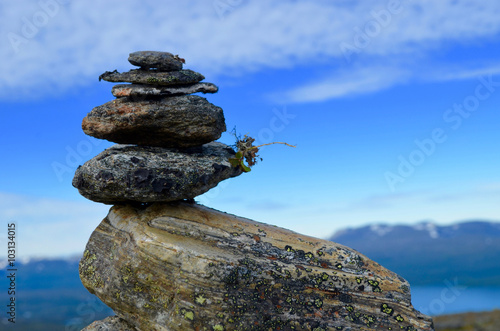 Stone cairn, stone man, trailmark construction on top of a mountain in subarctic Swedish Lapland
