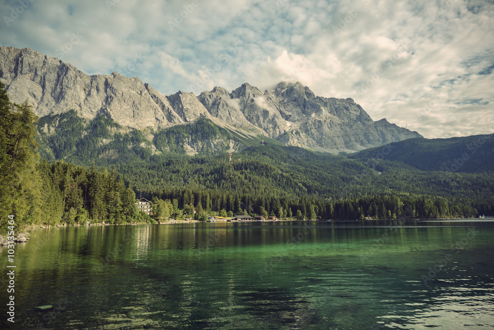 Eibsee lake and Zugspitze, at 2,962 meters, is the highest peak of the Wetterstein Mountains as well as the highest mountain in Germany, Europe, Vintage filtered style
