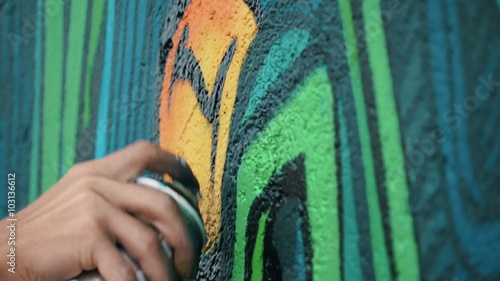 Graffiti artist drawing on the wall