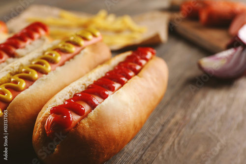 фотографія Hot dogs on wooden background closeup