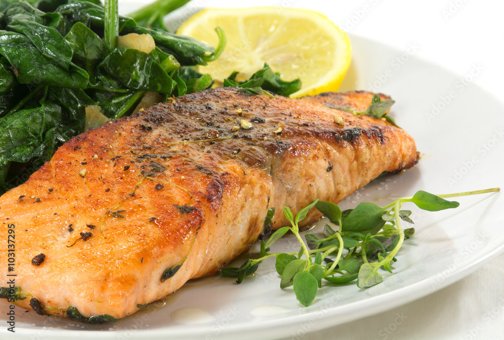 grilled salmon with thyme, lemon and spinach on white, vegetaria grilled salmon with thyme, lemon and spinach on white, vegetaria