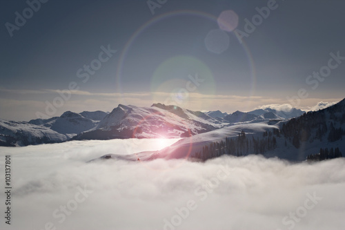 Über den Wolken - Bergpanorama Tirol im Winter mit Lens flare - Kitzbüheler Alpen, Tirol, Österreich photo