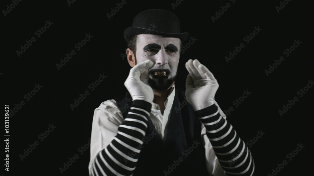 Young hilarious mime shouting using a megaphone Young hilarious mime shouting using a megaphone