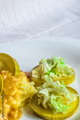 Mashed potatoes, gravy polytoe meat slices of fried meat. Salad of Chinese cabbage. Delicious lunch restaurant food. Dude looks sochno and delicious photo