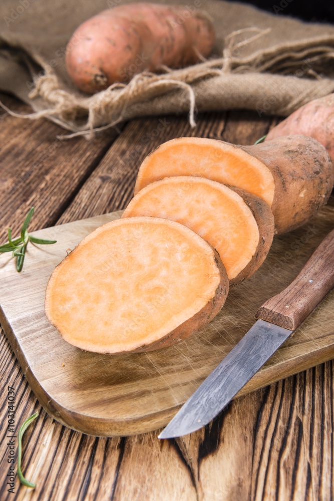 Sweet Potato (uncooked) on wooden background