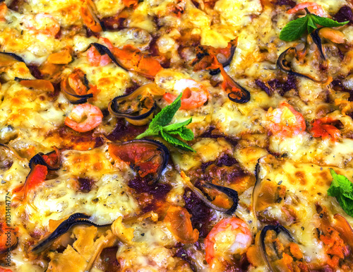 freshly baked pizza with seafood: mussels and shrimp clouse-up