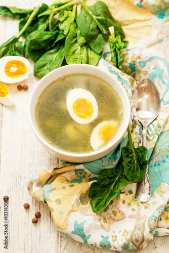   healthy lunch   green soup with sorrel or spinach   boiled egg and spices on wooden background