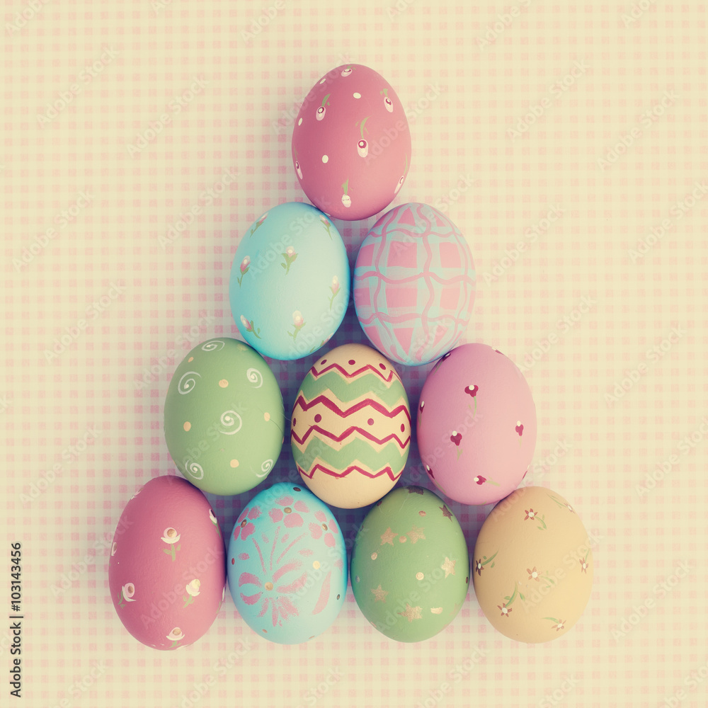 Vintage pastel easter eggs over checkered background