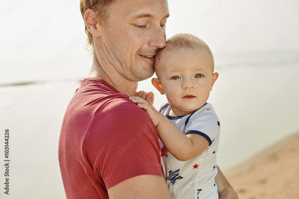 Portrait father with toddler son playing on the beach Portrait father with toddler son playing on the beach