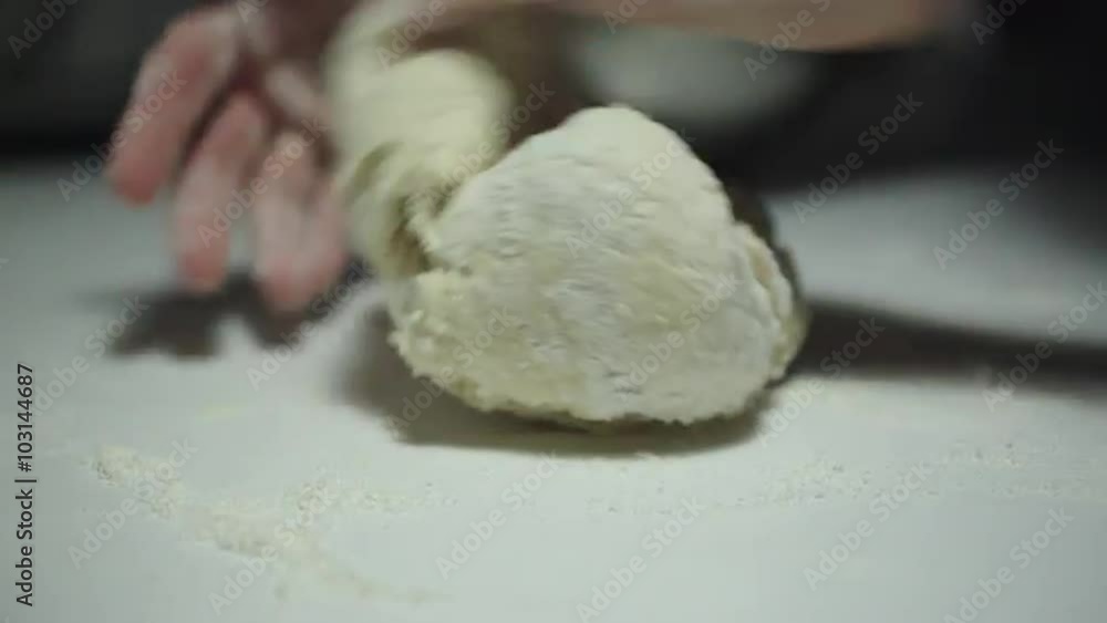 Woman kneading dough on the table Woman kneading dough on the table