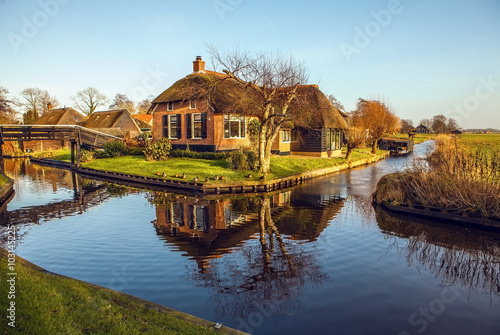 Old cozy house with thatched roof in Giethoorn, Netherlands. photo