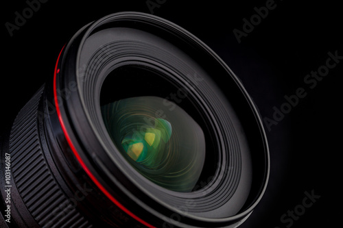 Wide anlge professinal camera photo lens with beautiful glass reflections isolated on black background