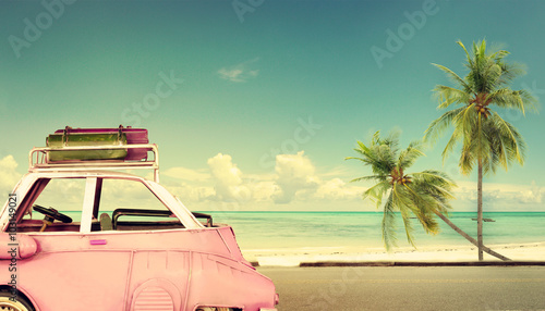Travel destination: vintage classic car parked near the beach with bags on a roof - Honeymoon trip in summer