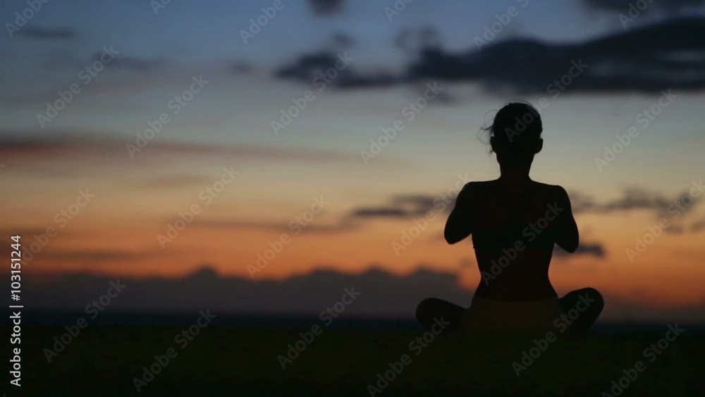 Yoga meditation woman meditating at beach sunset or sunrise relaxing in yoga pose. Serene relaxed female yoga instructor in calm nature sea scene. Yoga meditation woman meditating at beach sunset or sunrise relaxing in yoga pose. Serene relaxed female yoga instructor in calm nature sea scene.
