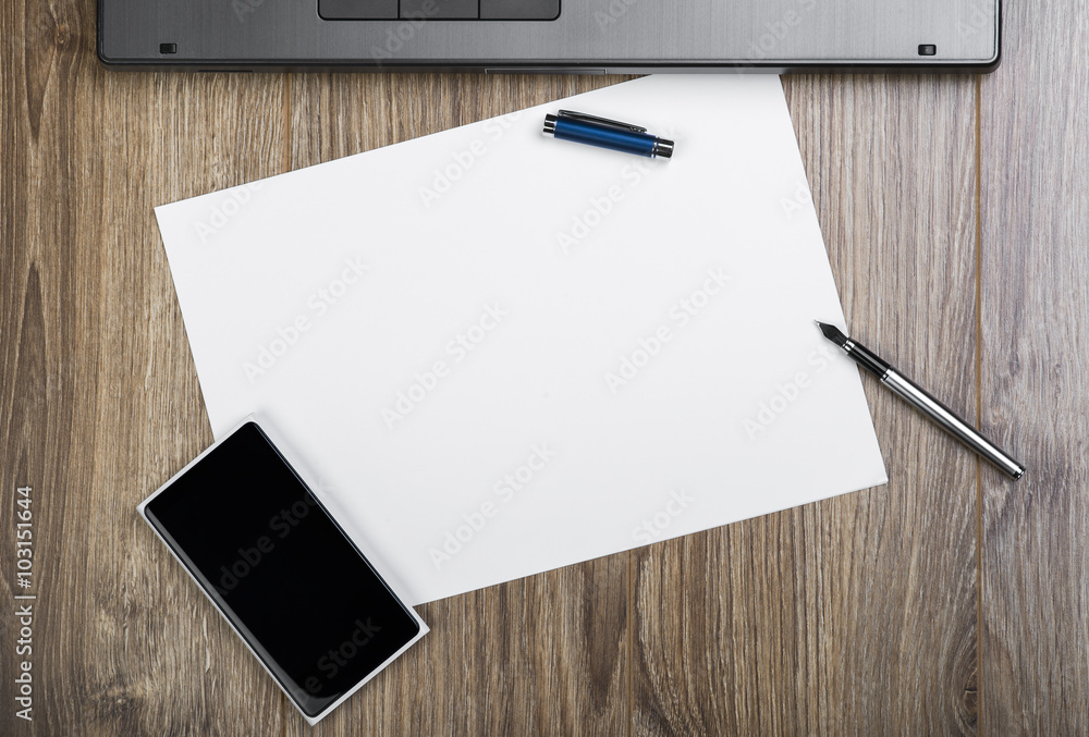 Top View Of An Office Desk With Laptop, Smartphone, Fountain Pen And
