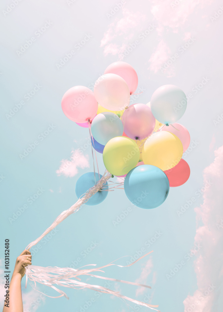Girl hand holding colorful balloons. happy birthday party. vintage pastel  filter effect Stock Photo | Adobe Stock
