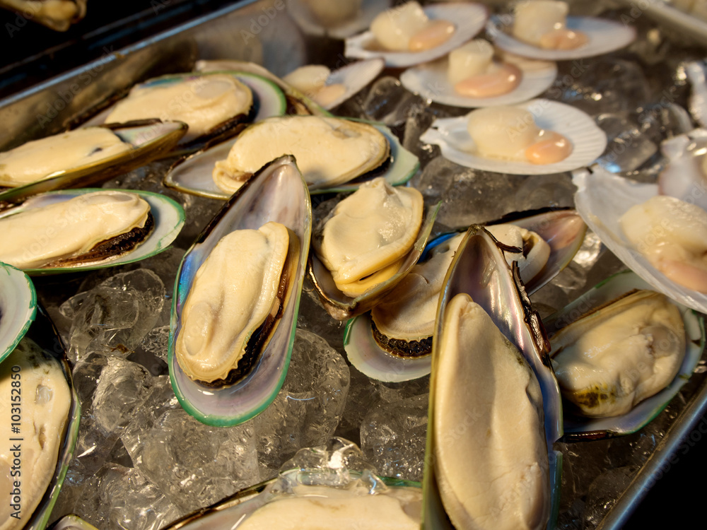Group of fresh green shell mussels on ice Group of fresh green shell mussels on ice