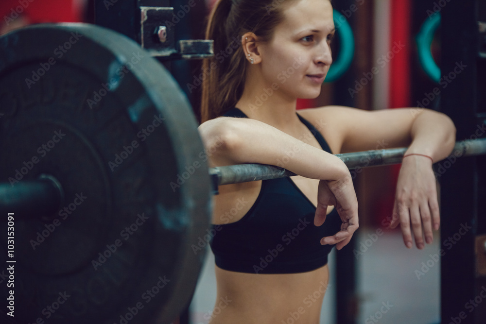 Sport girl is preparing for the exercises with barbell Sport girl is preparing for the exercises with barbell