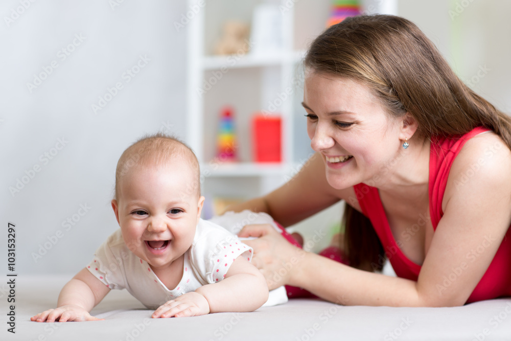 Happy cheerful family. Mother and baby playing, laughing and hugging Happy cheerful family. Mother and baby playing, laughing and hugging